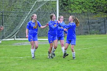 Photo by Christopher Lugo/Staff Kayden Pierson, Claire Worley and Anne Elizabeth Woods congratulate Charlotte Westendorf after a goal on Friday afternoon. 