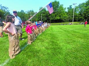 Photo by Christopher Lugo/Staff Kids lined up for the sack race at last year’s Fourth of July events. 