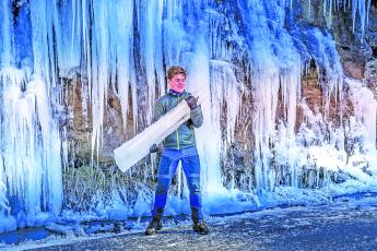 Bridal Veil Falls provided a frozen souvenir for a young visitor on Saturday. Temperatures in the single digits and wind chills below zero hit Highlands during the holiday weekend.